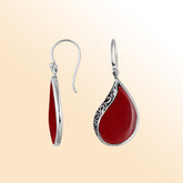 Handcrafted sterling silver teardrop drop earrings with bold red coral inlay and Balinese scrollwork design